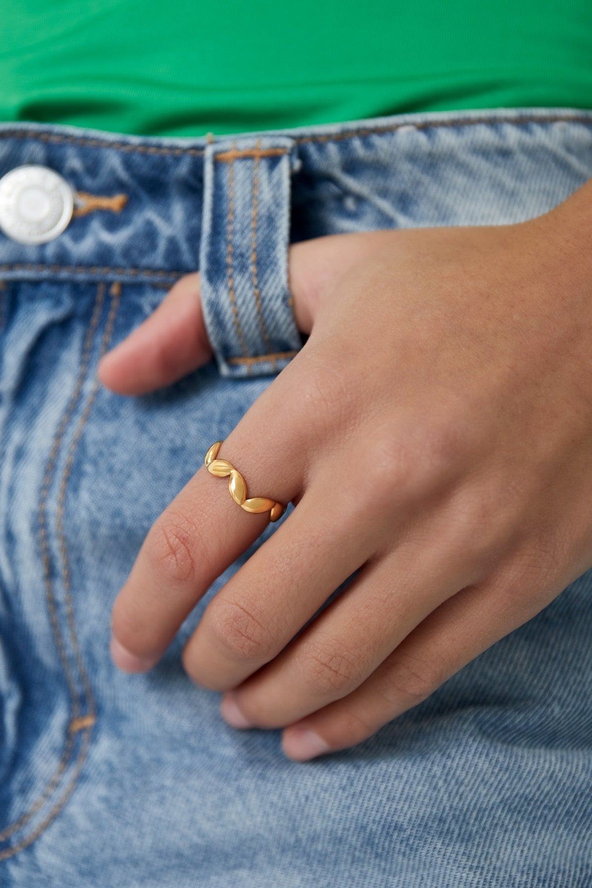 Ring met golfjes in het goud om vinger