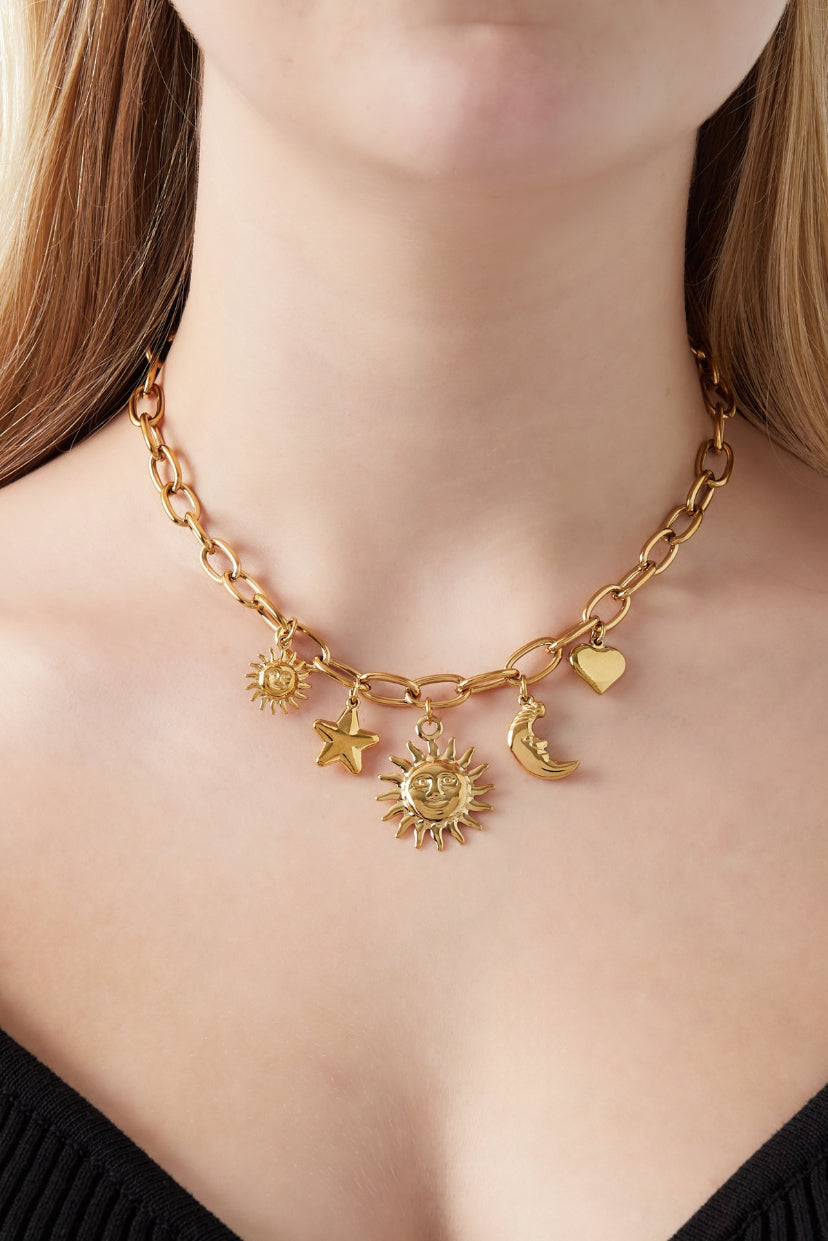 Statement schakelketting met bedels van maan, zon, ster en hart in het goud op model