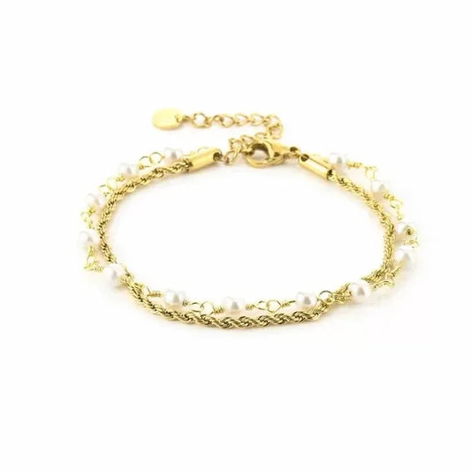 Armband met gedraaide schakel en parels in het goud