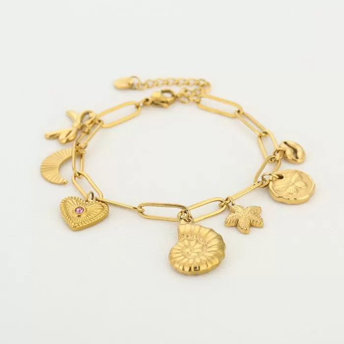 Bedelarmband met bedels van strik, schelp, ster, lipjes en hart goudkleurig
